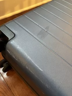 Scuffs on Quince suitcase after 1.5 years of use